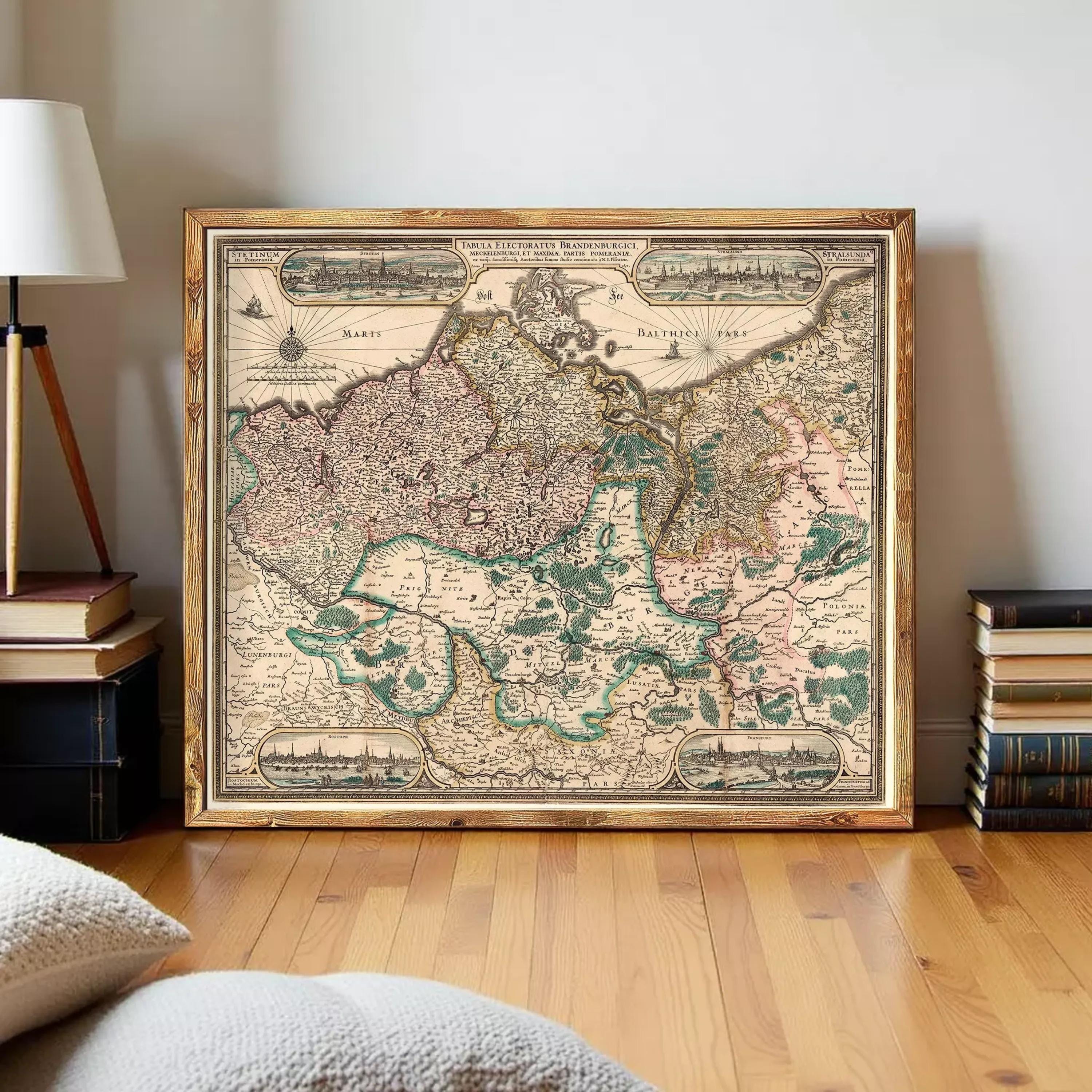a large, framed map of Europe, with various regions and countries clearly labeled. The map is displayed on a wooden floor, with a lamp and a stack of books visible in the background.