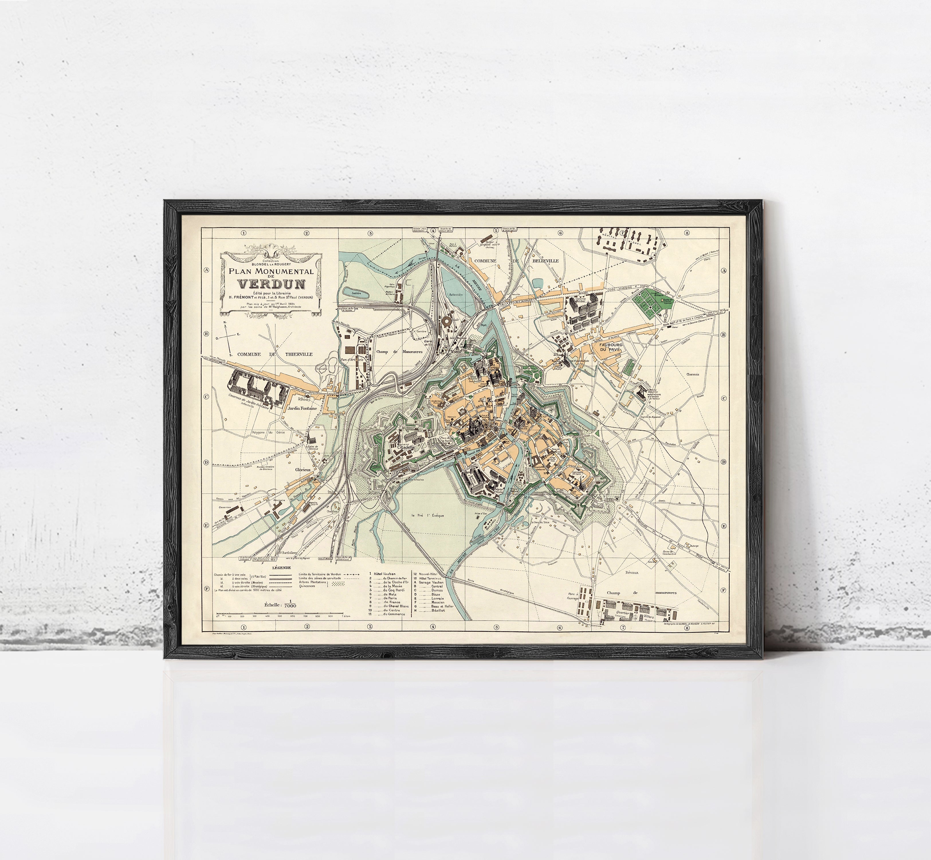 The image is a framed vintage map of a city, depicting various landmarks and streets.