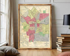 The image is a framed map of a city, showing various neighborhoods and streets.