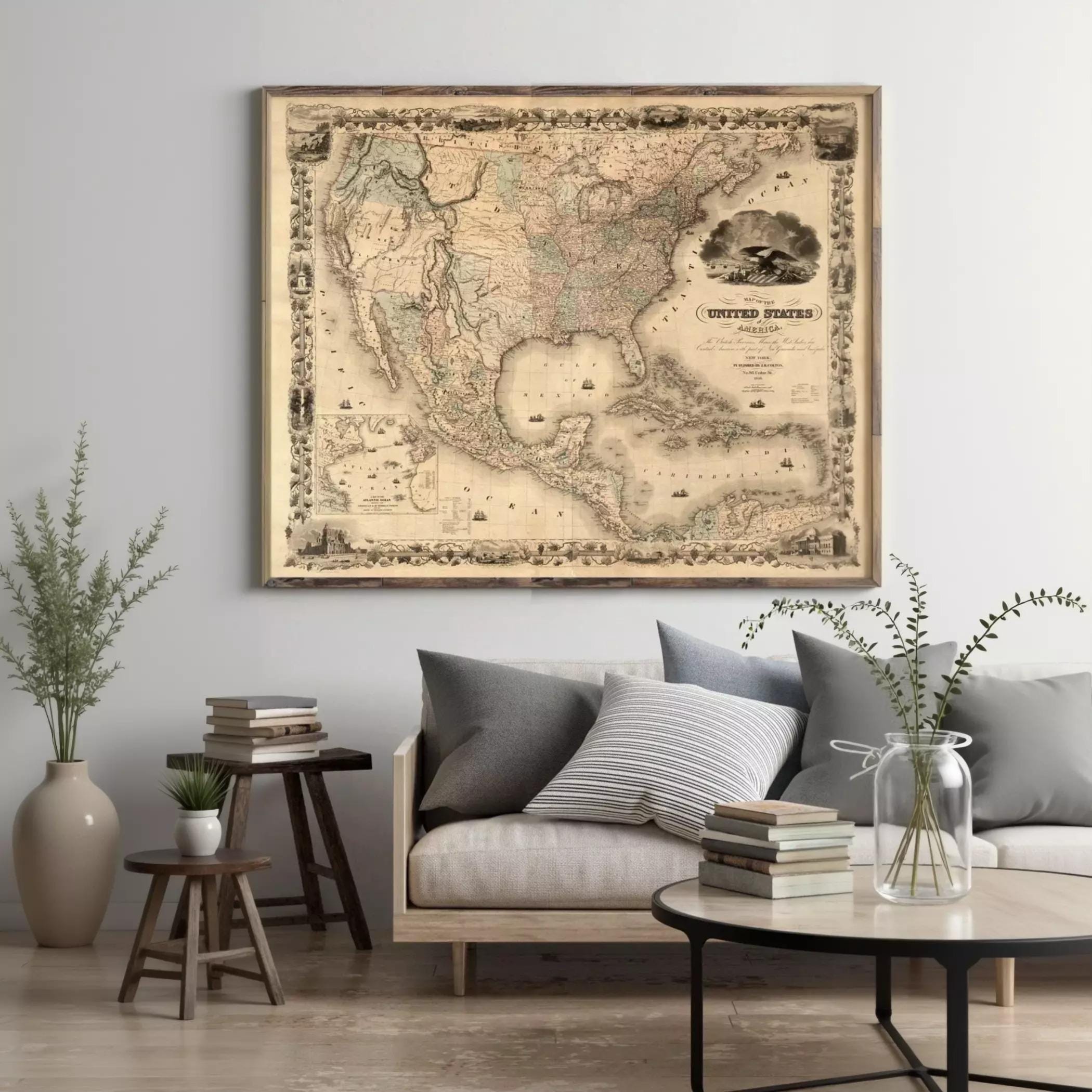 a large framed map of the United States hanging on a wall above a couch with pillows and a coffee table in a living room setting.