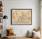 The image is a framed map of a city, likely London, with various streets, landmarks, and other geographical features depicted.