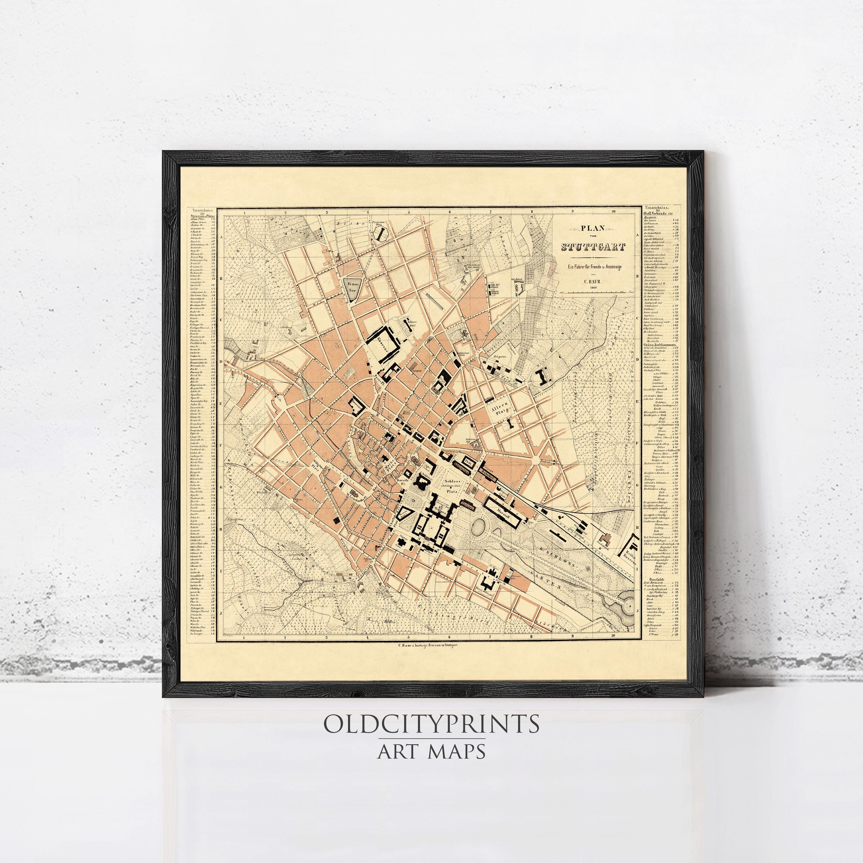 The image is a framed vintage map of a city, likely from the 19th century, with a black border and a beige background.