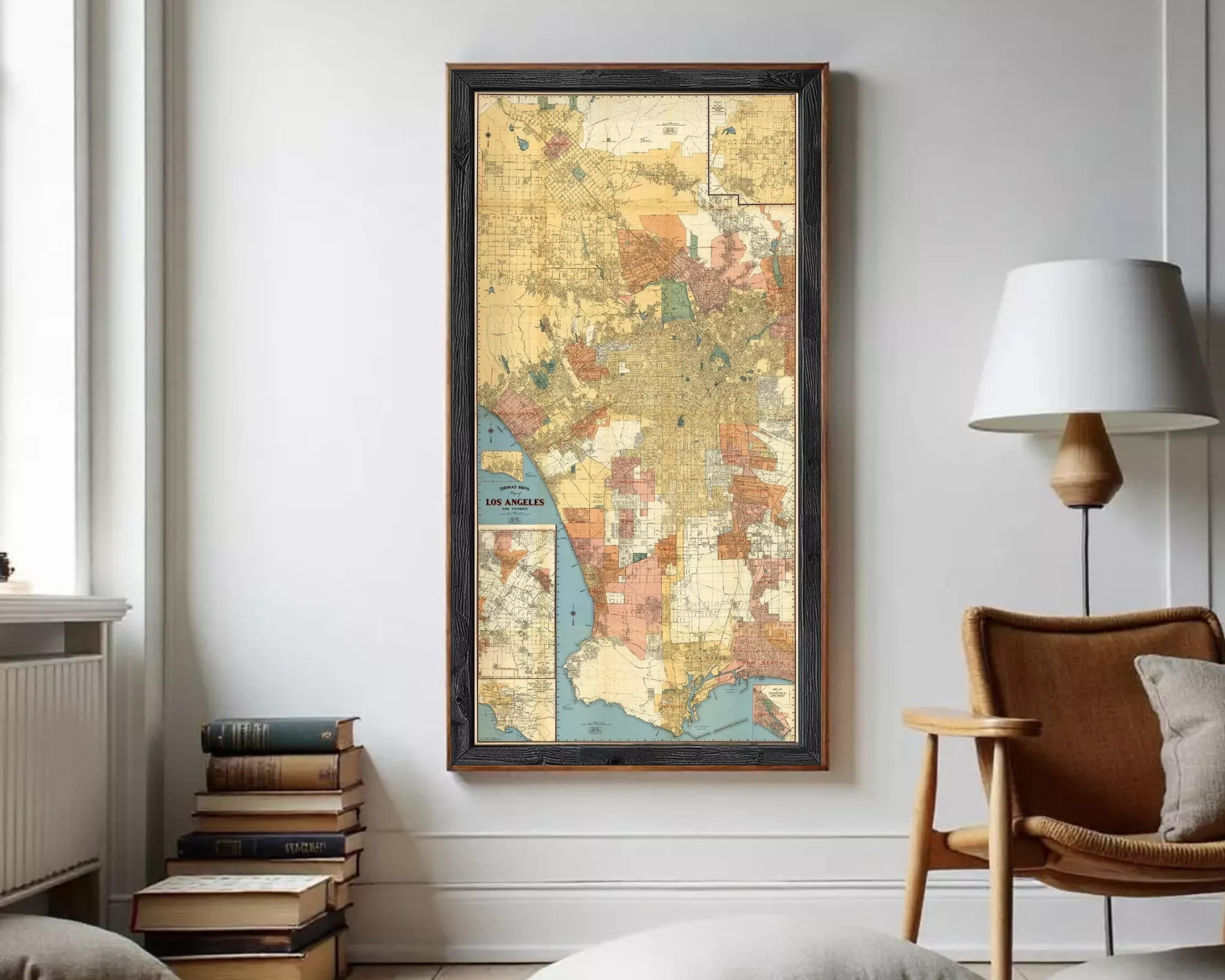 The image is a framed vintage map of Los Angeles, California, with a black border and a colorful, detailed depiction of the city's streets and neighborhoods.
