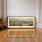 A large framed black and white map of a city or region, depicting a detailed aerial view of the area.