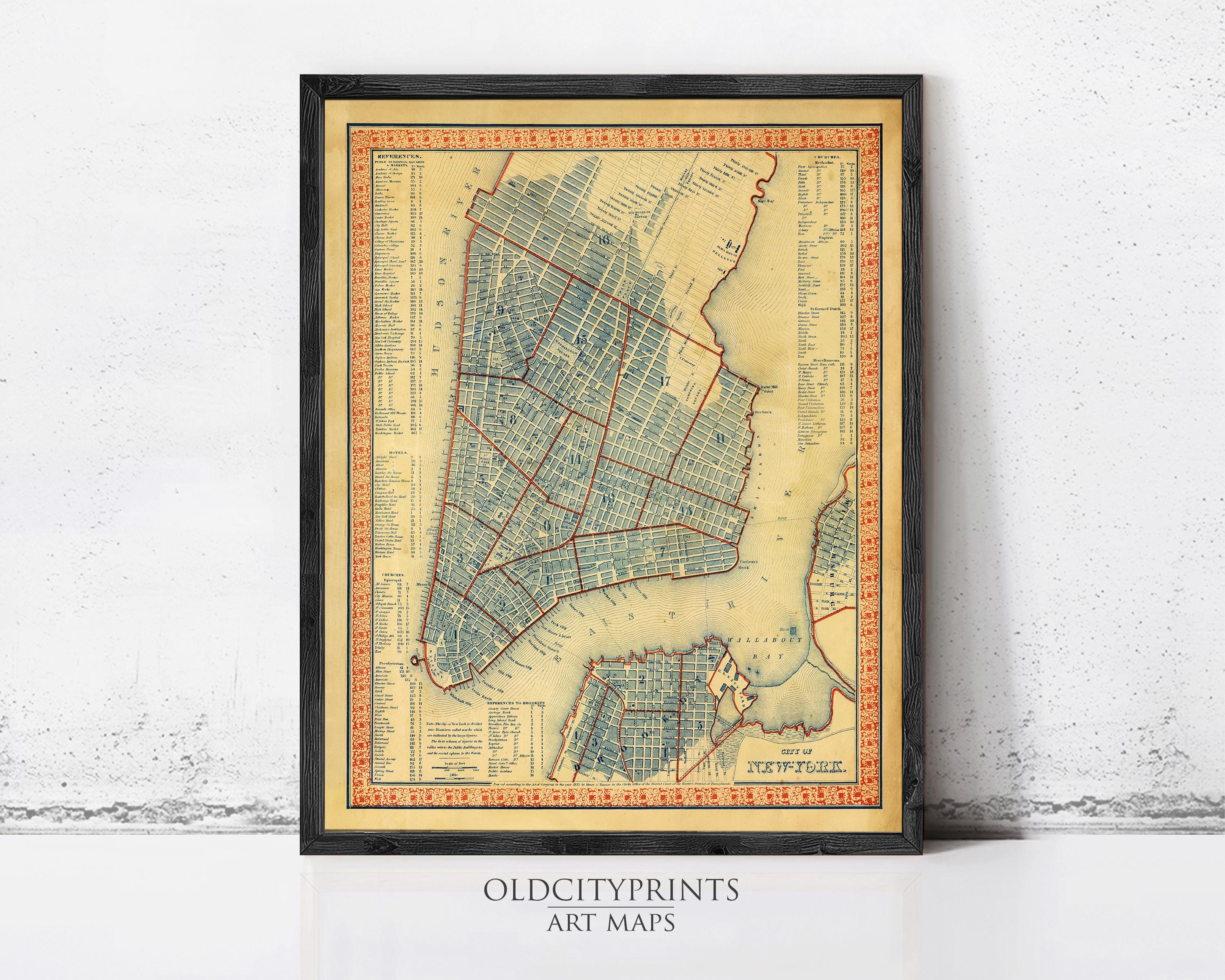 The image is a framed vintage map of New York City, depicting the city's streets and neighborhoods in a detailed and colorful manner.