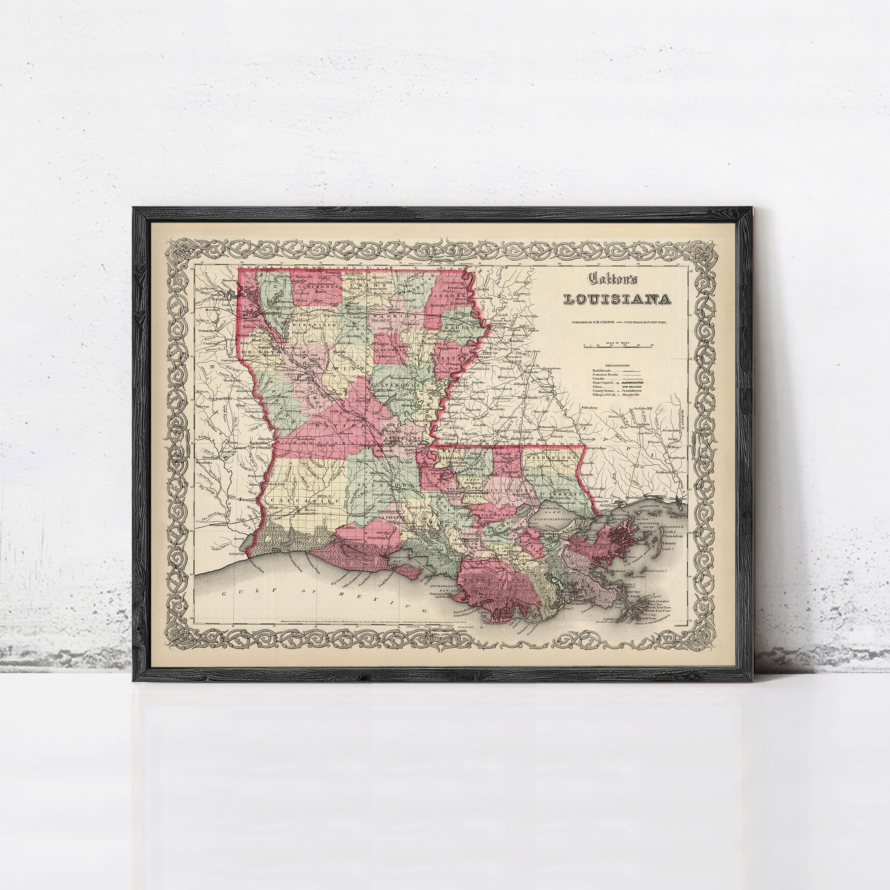 The image is a framed vintage map of Louisiana, depicting the state in a detailed and colorful manner.