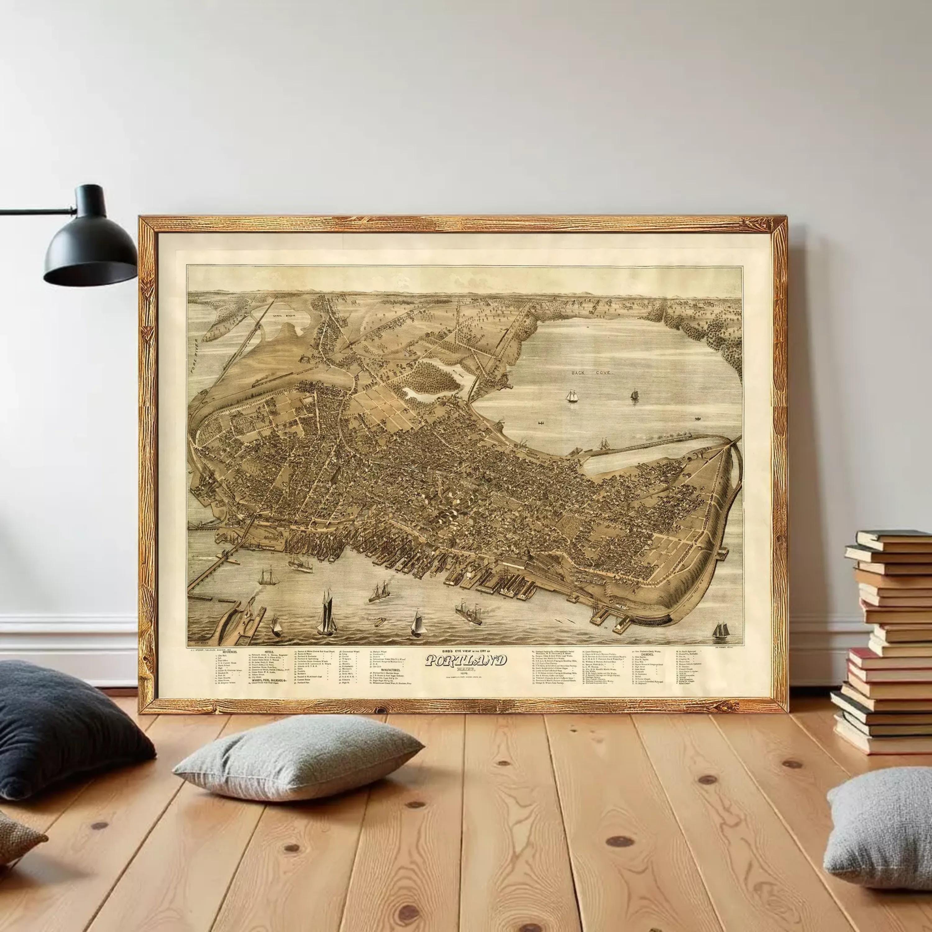 a large framed map of a city, with a wooden floor and a stack of books in the background.