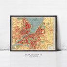 The image is a framed vintage map of a city, likely from the early 20th century, with a color palette of red, yellow, and green.