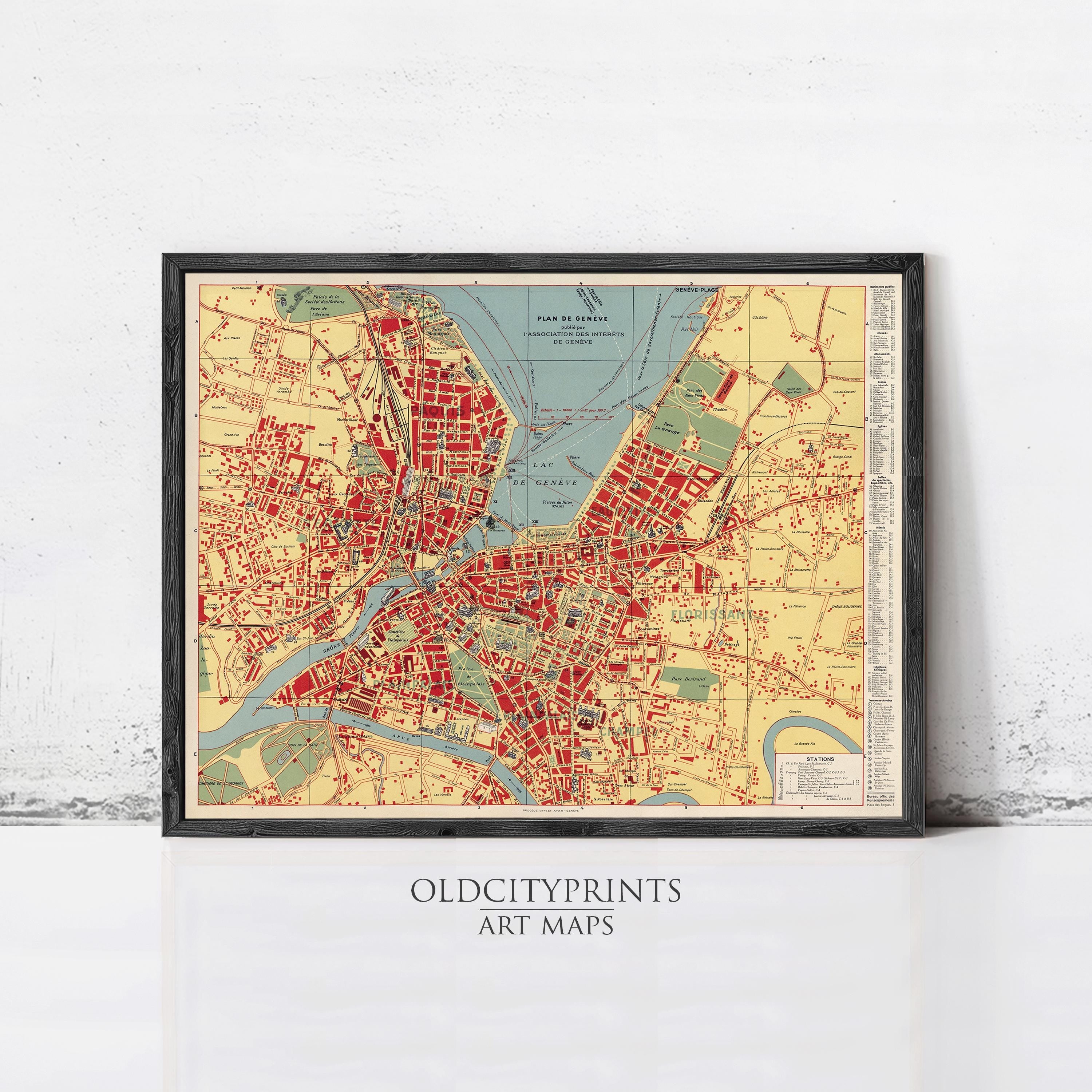 The image is a framed vintage map of a city, likely from the early 20th century, with a color palette of red, yellow, and green.