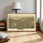 a large framed map of the city of Scranton, Pennsylvania, with a lamp and books in the background.