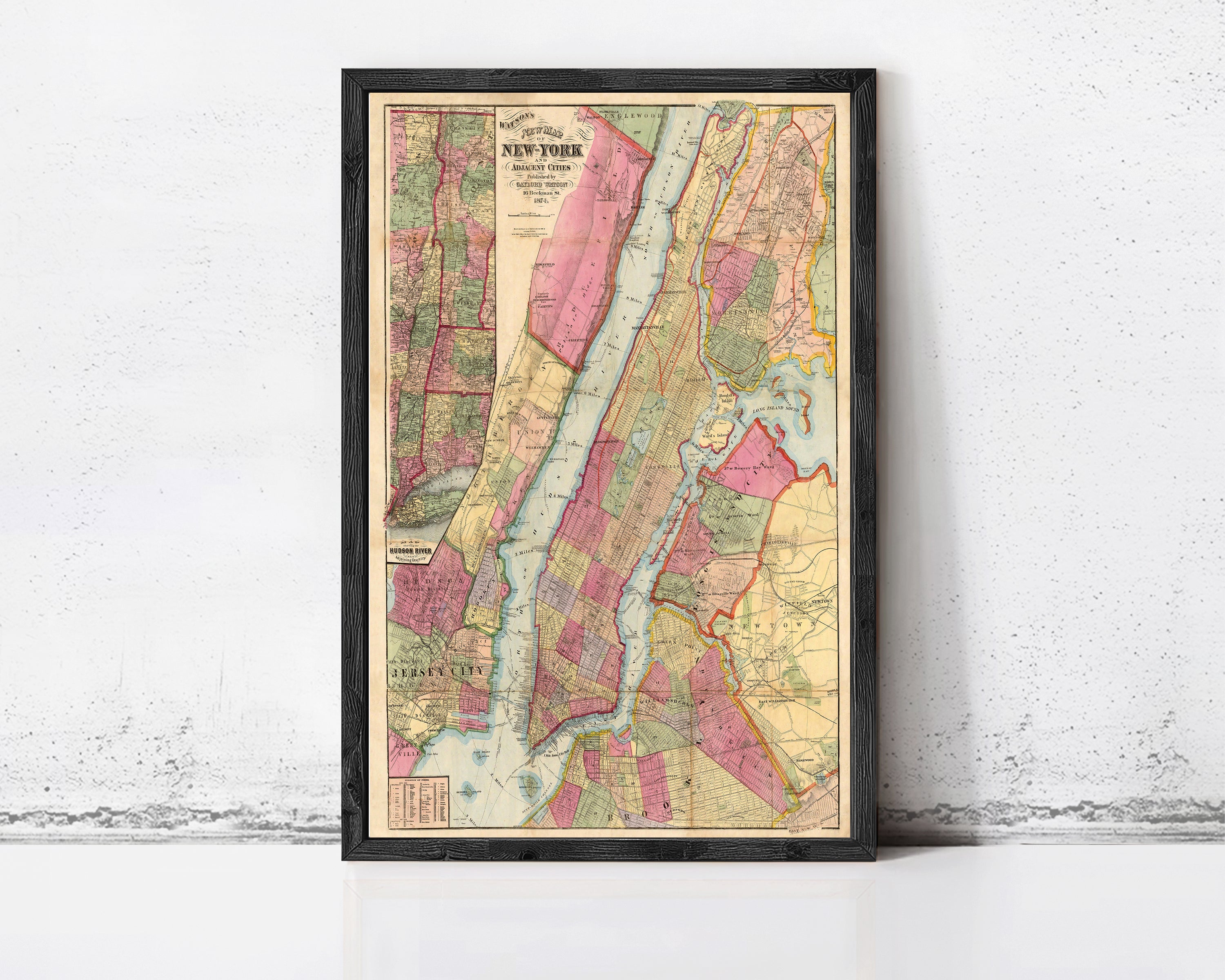 The image is a framed vintage map of New York City, depicting the city's streets, neighborhoods, and surrounding areas.