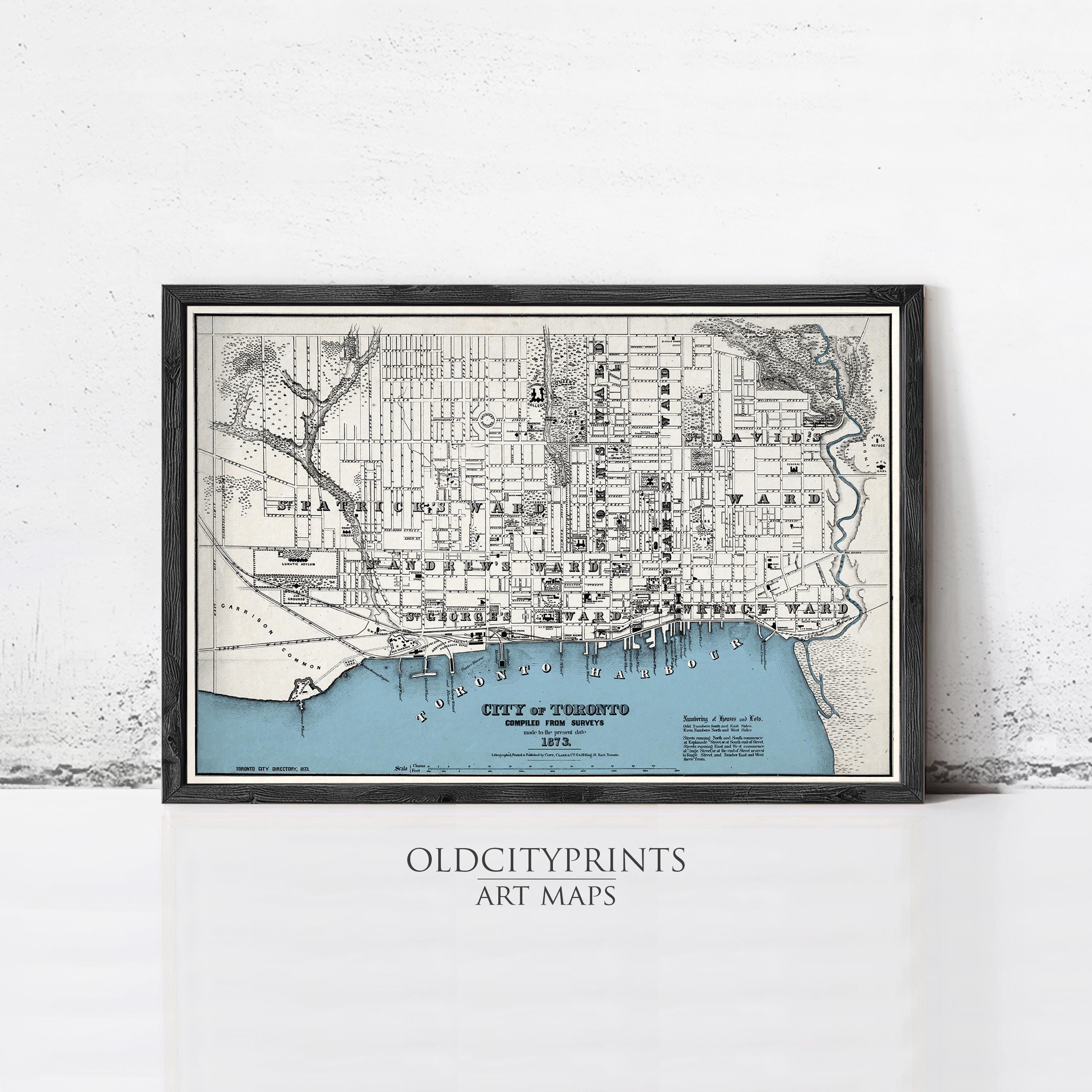 The image is a framed vintage map of Toronto, Canada, depicting the city's streets and surrounding areas.