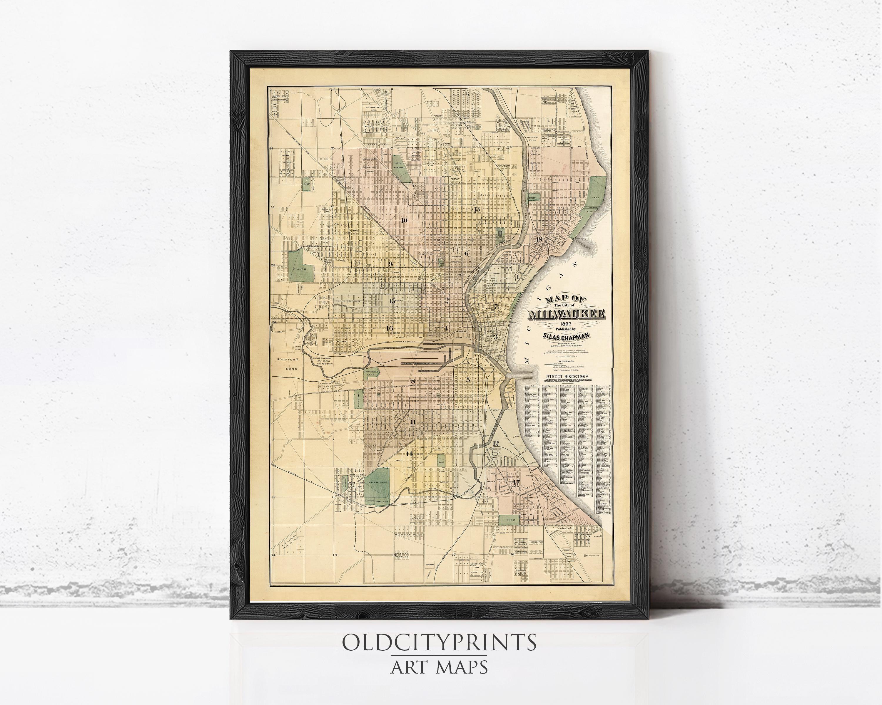 The image is a framed vintage map of Milwaukee, Wisconsin, depicting the city's streets and neighborhoods.