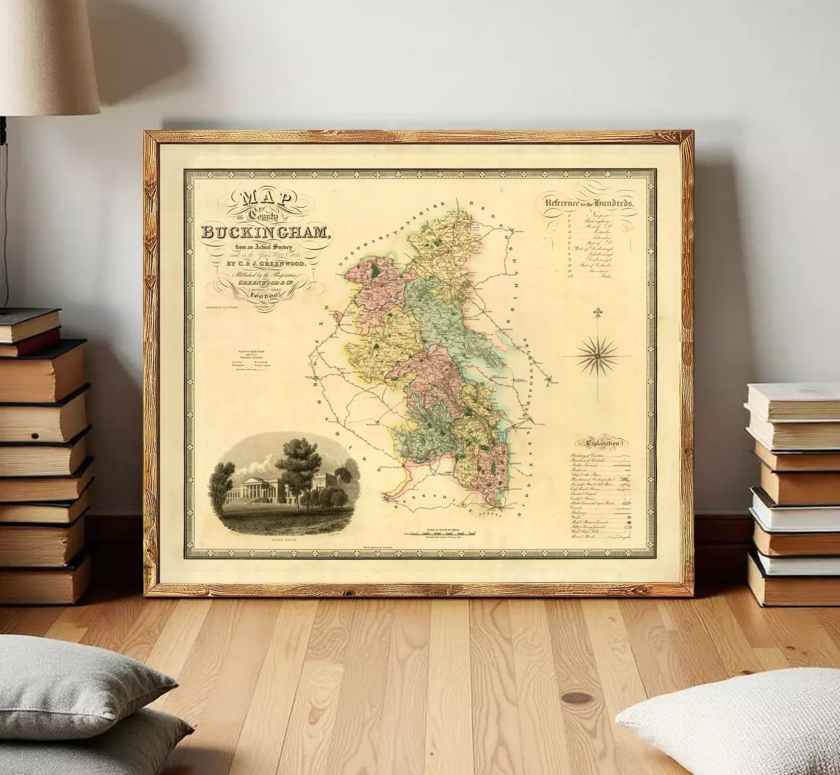 The image is a framed antique map of the city of Buckingham, England, with a detailed illustration of a building and surrounding landscape.