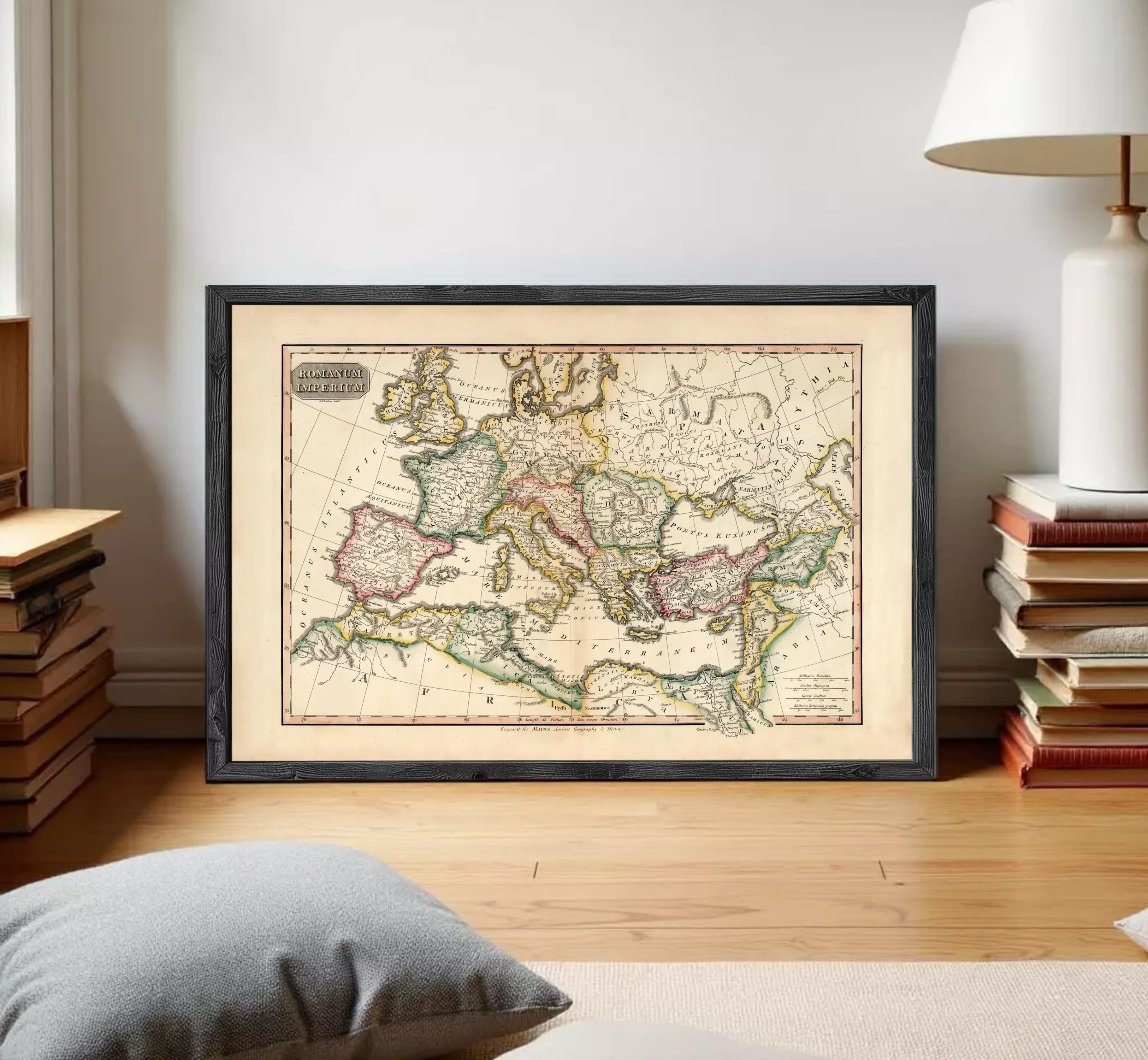 The image is a framed antique map of Europe and the Mediterranean region, displayed on a white wall.