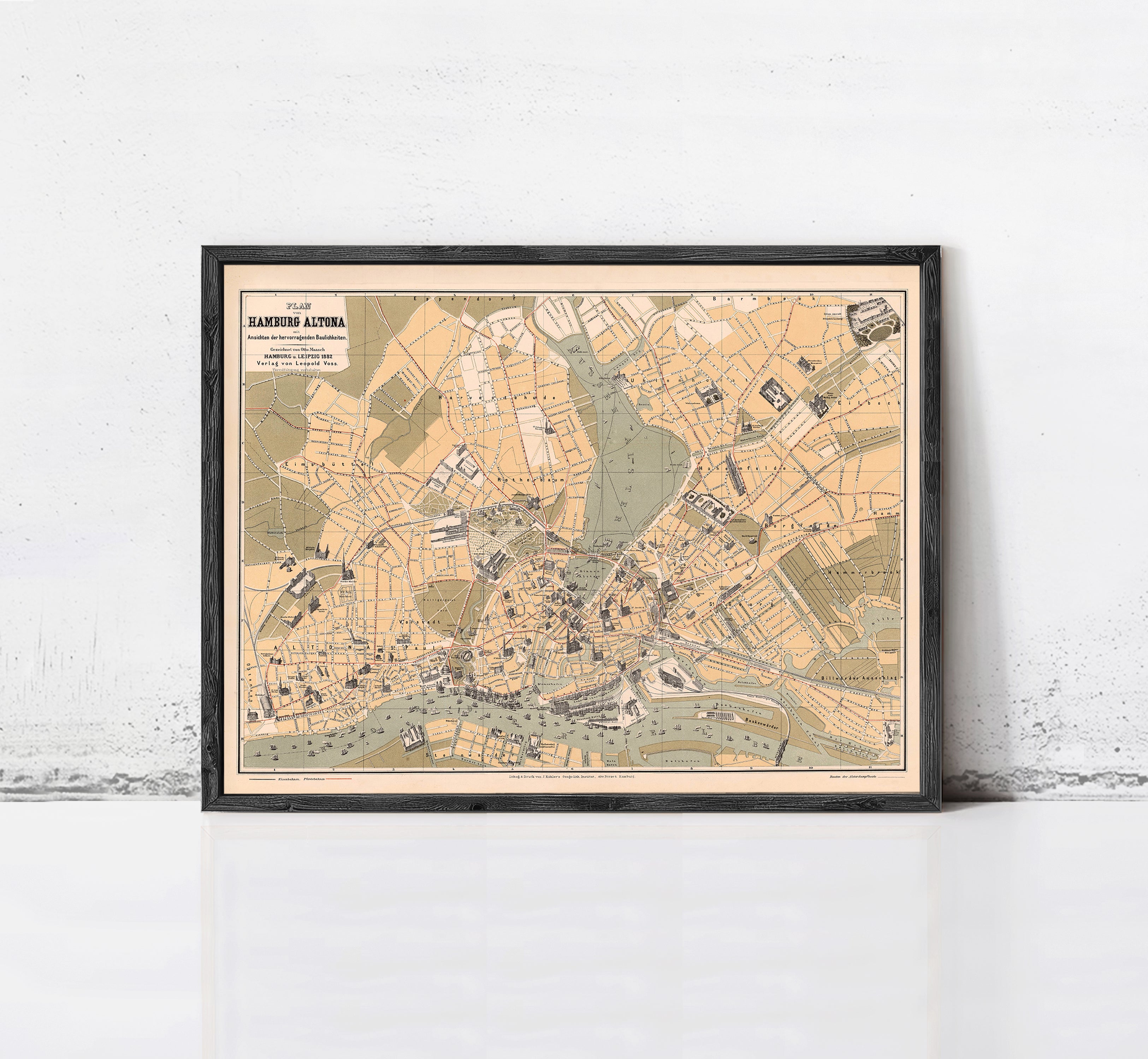 The image is a framed map of a city, likely London, with various streets, landmarks, and other geographical features depicted.