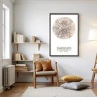 a cozy living room with a large framed map of Dresden, Germany, hanging on the wall. The room is furnished with a wooden chair, a bookshelf filled with books, and a rug on the floor.