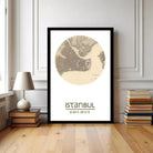 A framed map of Istanbul, Turkey, with the text "ISTANBUL 41:00 28:57" printed on it, is displayed on a wall in a room with a lamp and books.