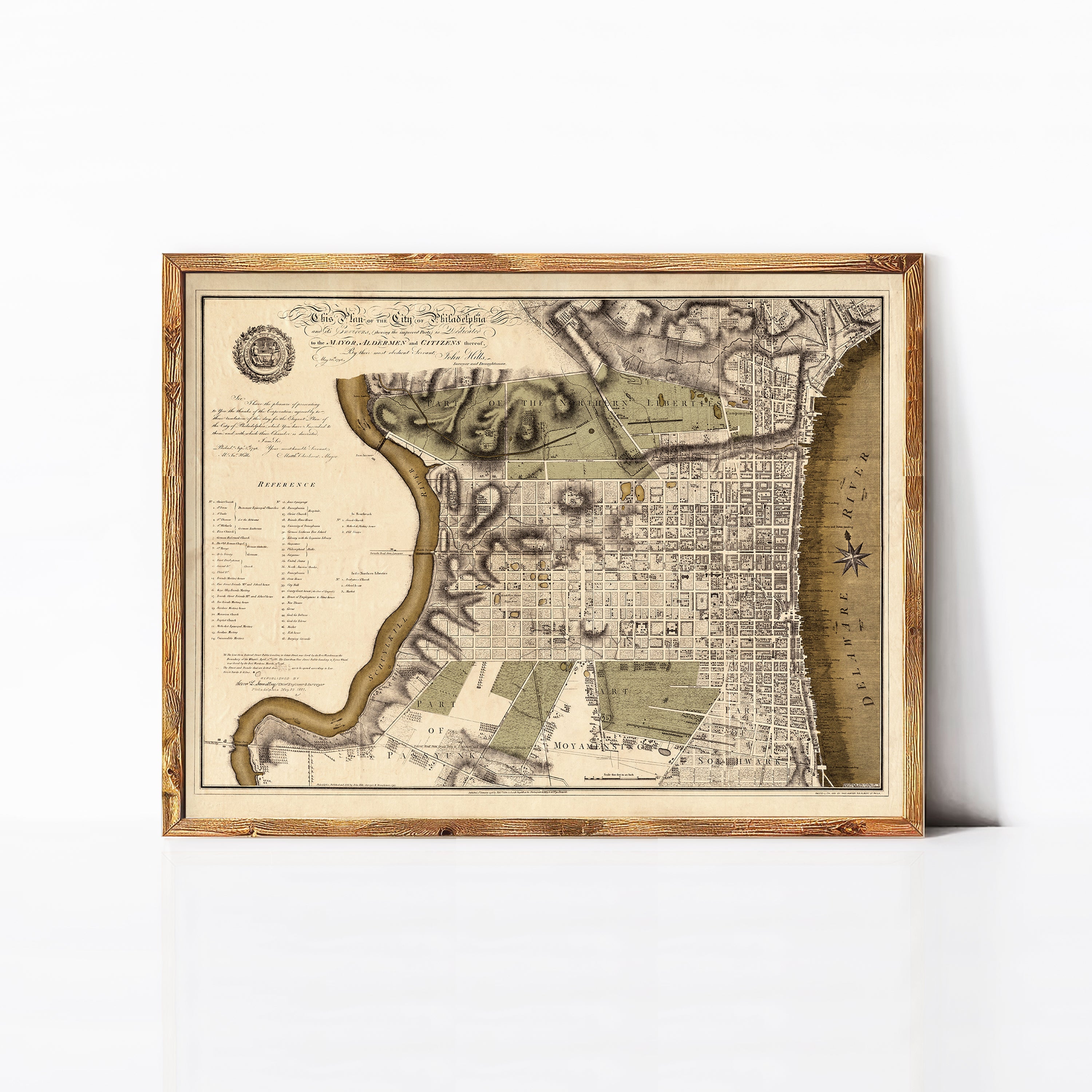 The image is a framed antique map of Philadelphia, Pennsylvania, depicting the city's layout and surrounding areas.