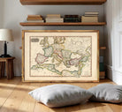 The image is a framed antique map of Europe and the Mediterranean region, displayed on a white wall.