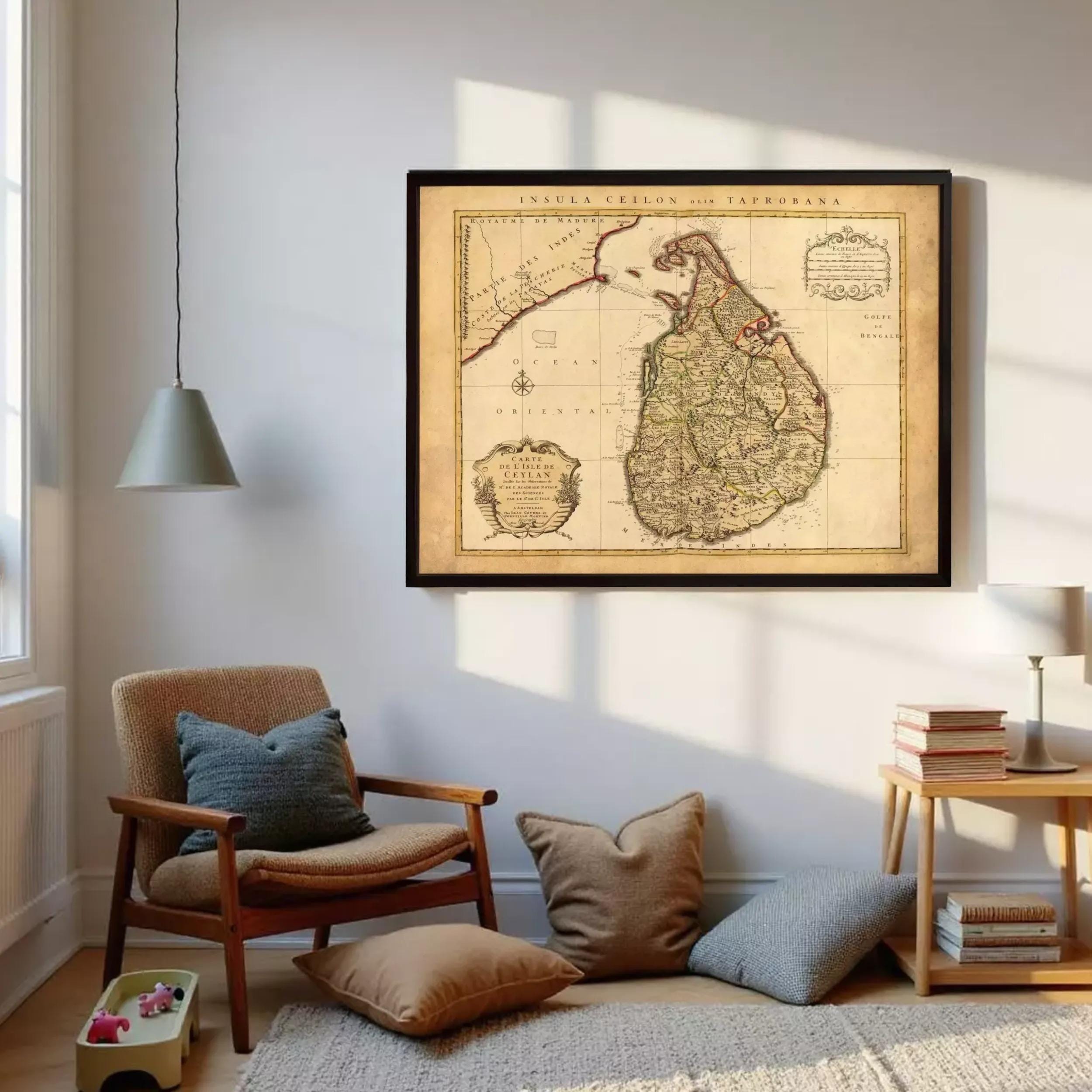 a cozy living room with a large framed map of Sri Lanka hanging on the wall. The room is furnished with a wooden chair, a small side table, and a stack of books. The overall atmosphere of the room appears warm and inviting, with the map serving as a focal point on the wall.