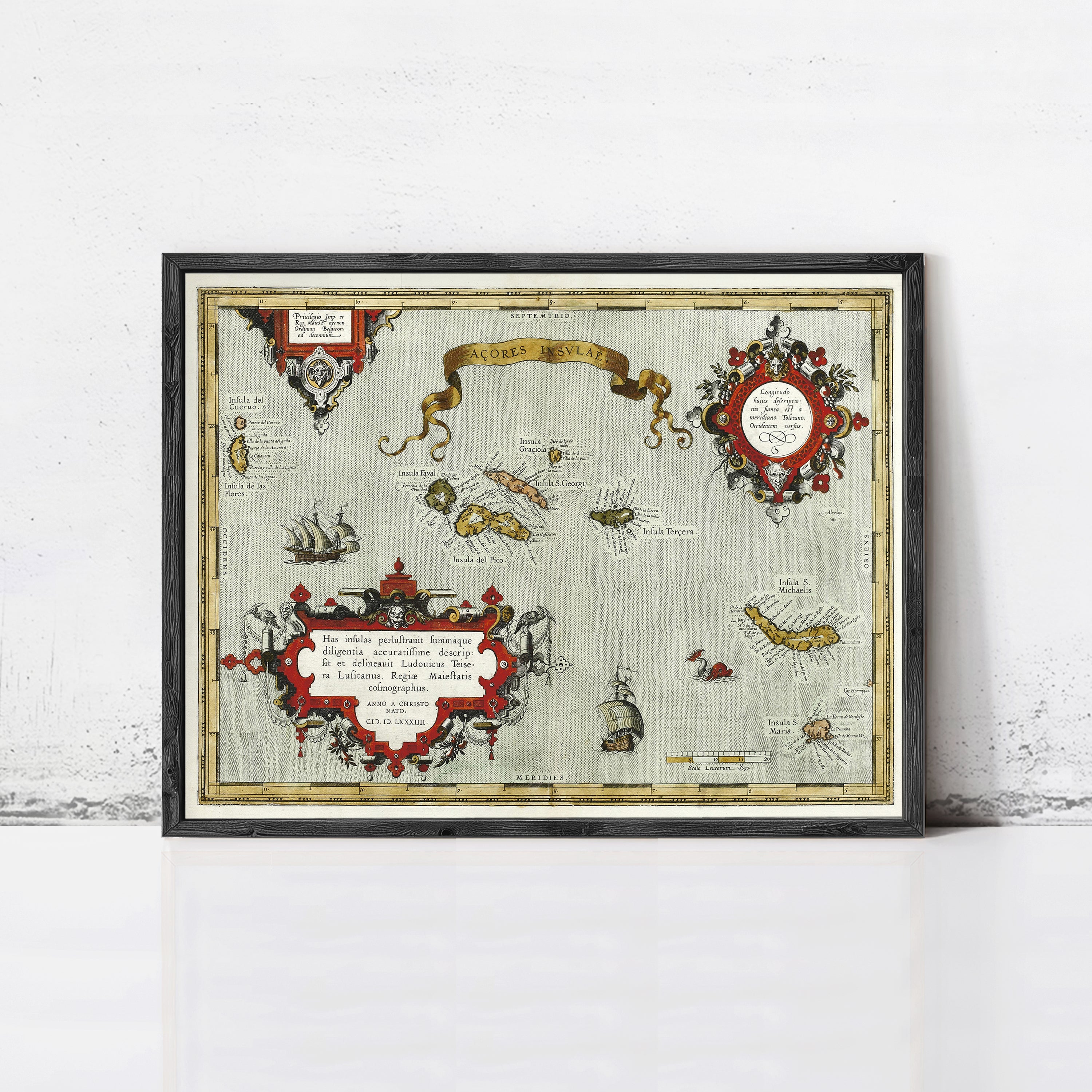 The image is a framed vintage map with various illustrations and text, including a banner at the top.