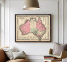 The image is a framed vintage map of Australia, depicting the country in a detailed and intricate manner.
