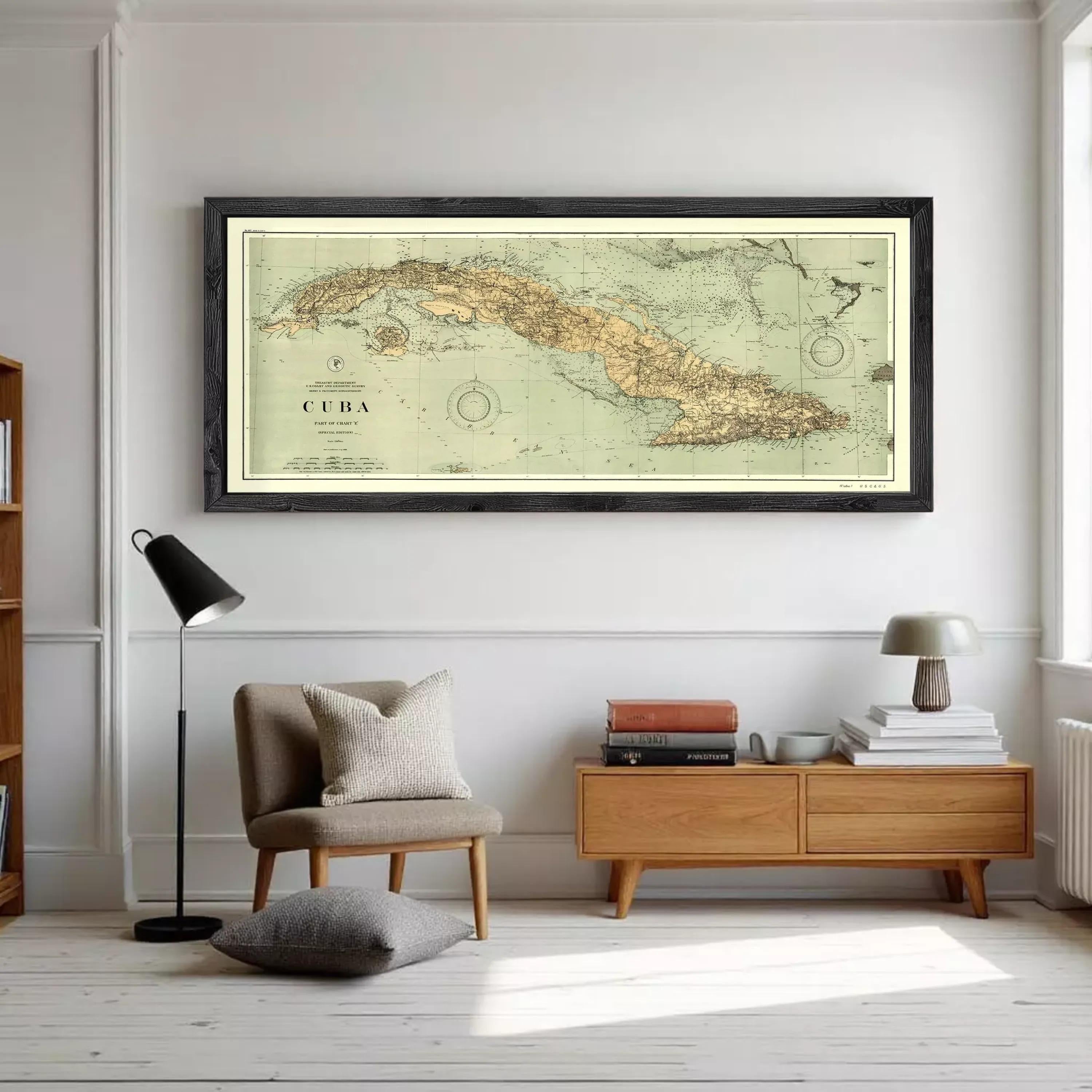 A framed vintage map of Cuba is displayed against a white wall.