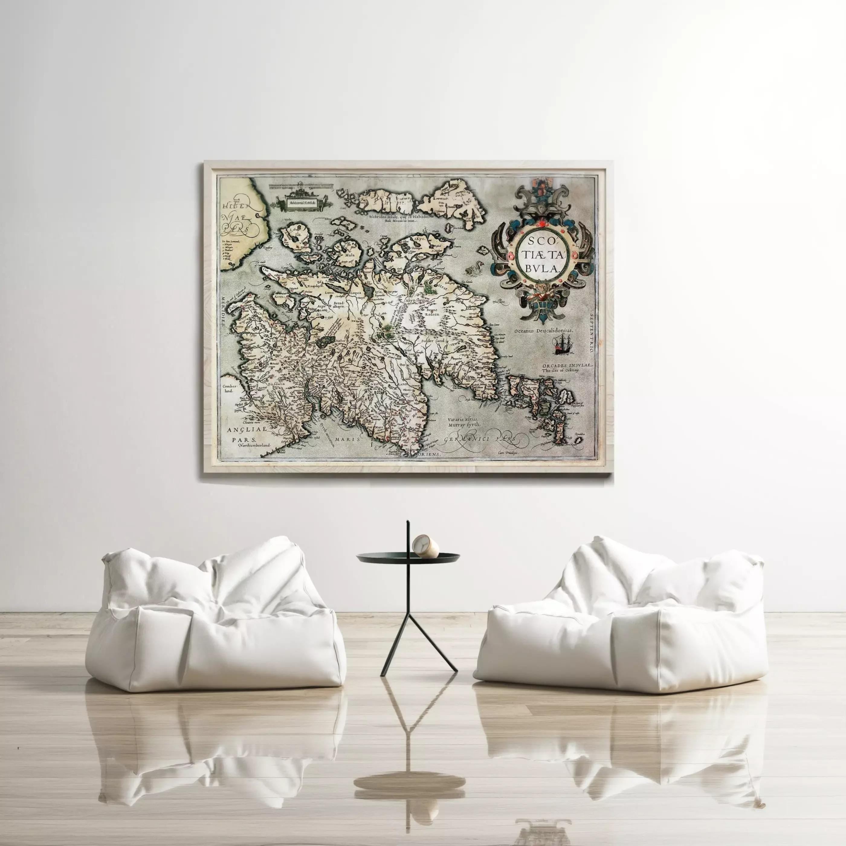a large, old map of the world hanging on a white wall, with two white bean bag chairs positioned in front of it.