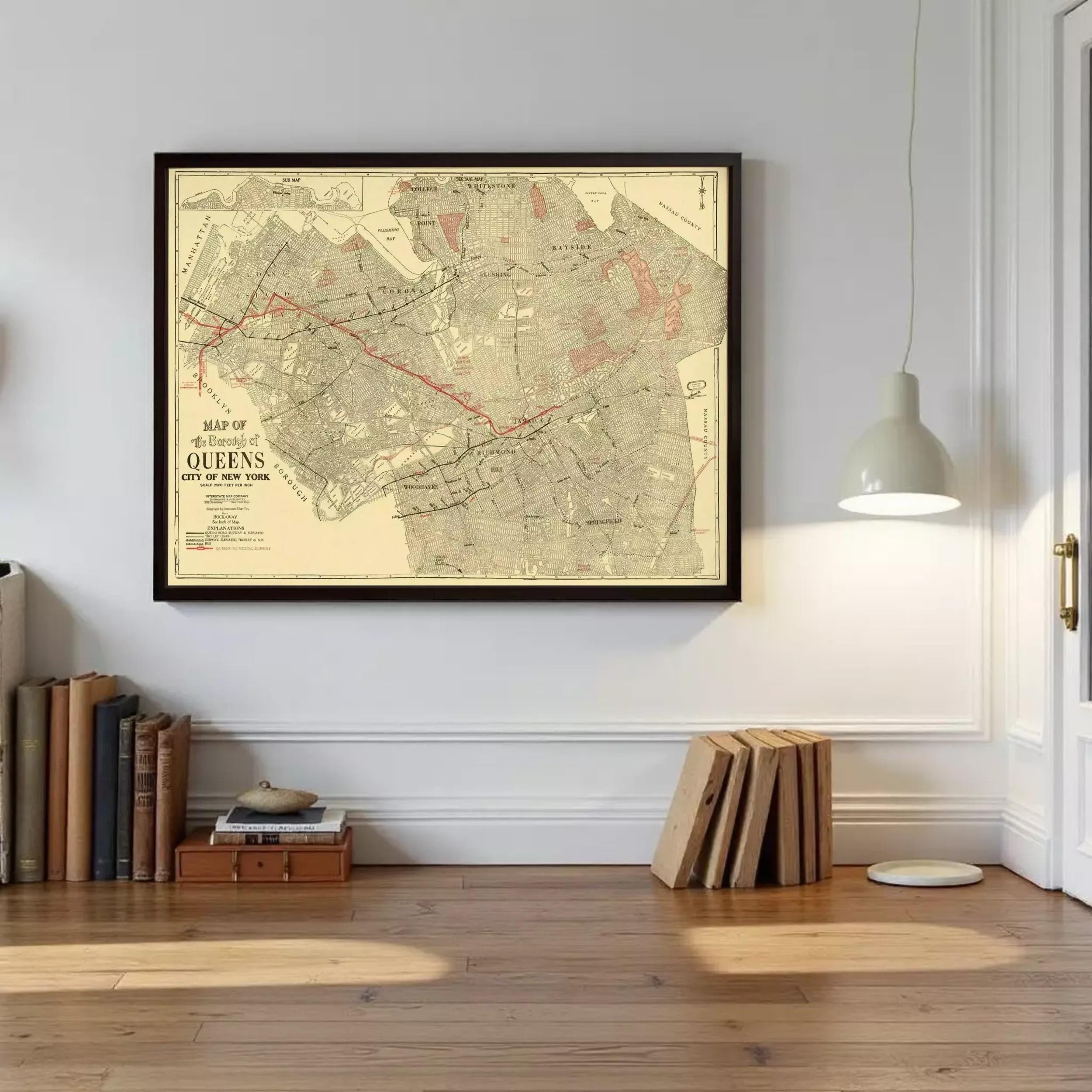 a framed map of the city of Queens, New York, hanging on a wall.