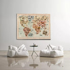 a large world map hanging on a wall, with two white bean bag chairs positioned in front of it.