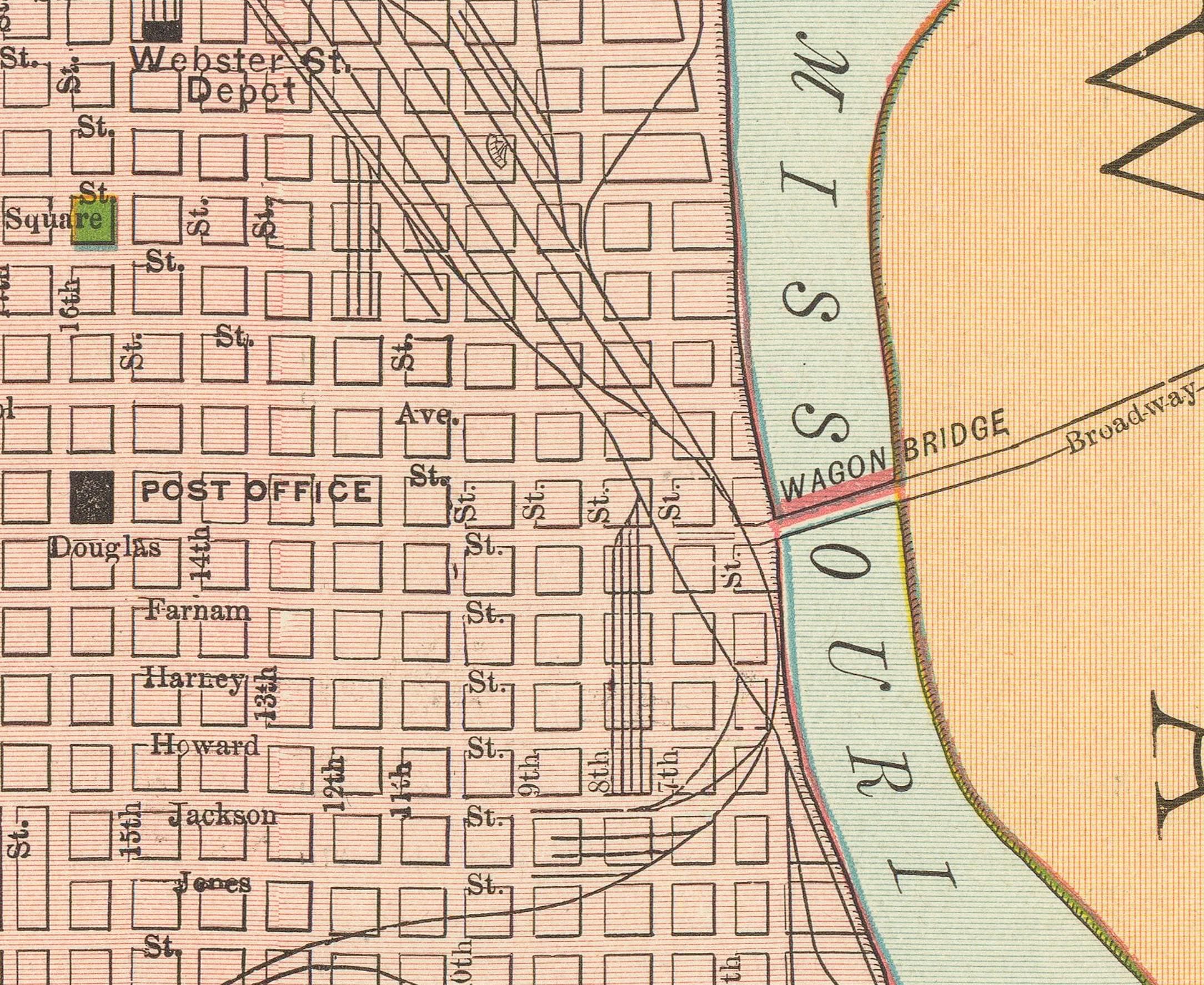 The image is a vintage map of a city, showing streets, buildings, and a river.