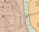 The image is a vintage map of a city, showing streets, buildings, and a river.