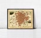 The image is a framed vintage map of a city, likely Paris, with a detailed and colorful depiction of the city's streets and landmarks.