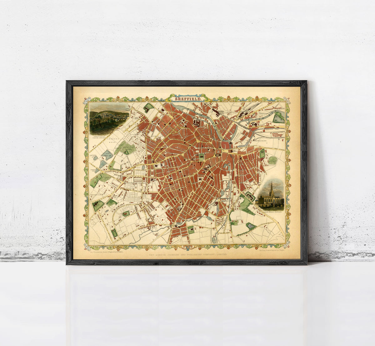 The image is a framed vintage map of a city, likely Paris, with a detailed and colorful depiction of the city's streets and landmarks.