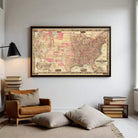 a large framed map of the United States hanging on a wall in a living room.