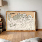 The image is a framed map of Hobart, Australia, showing the city's streets, landmarks, and surrounding areas.
