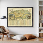 a large framed map hanging on a wall in a room with a bookshelf and a chair.