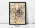 The image is a framed vintage map of a city, likely from the early 20th century, depicting the city's streets, neighborhoods, and other urban features.