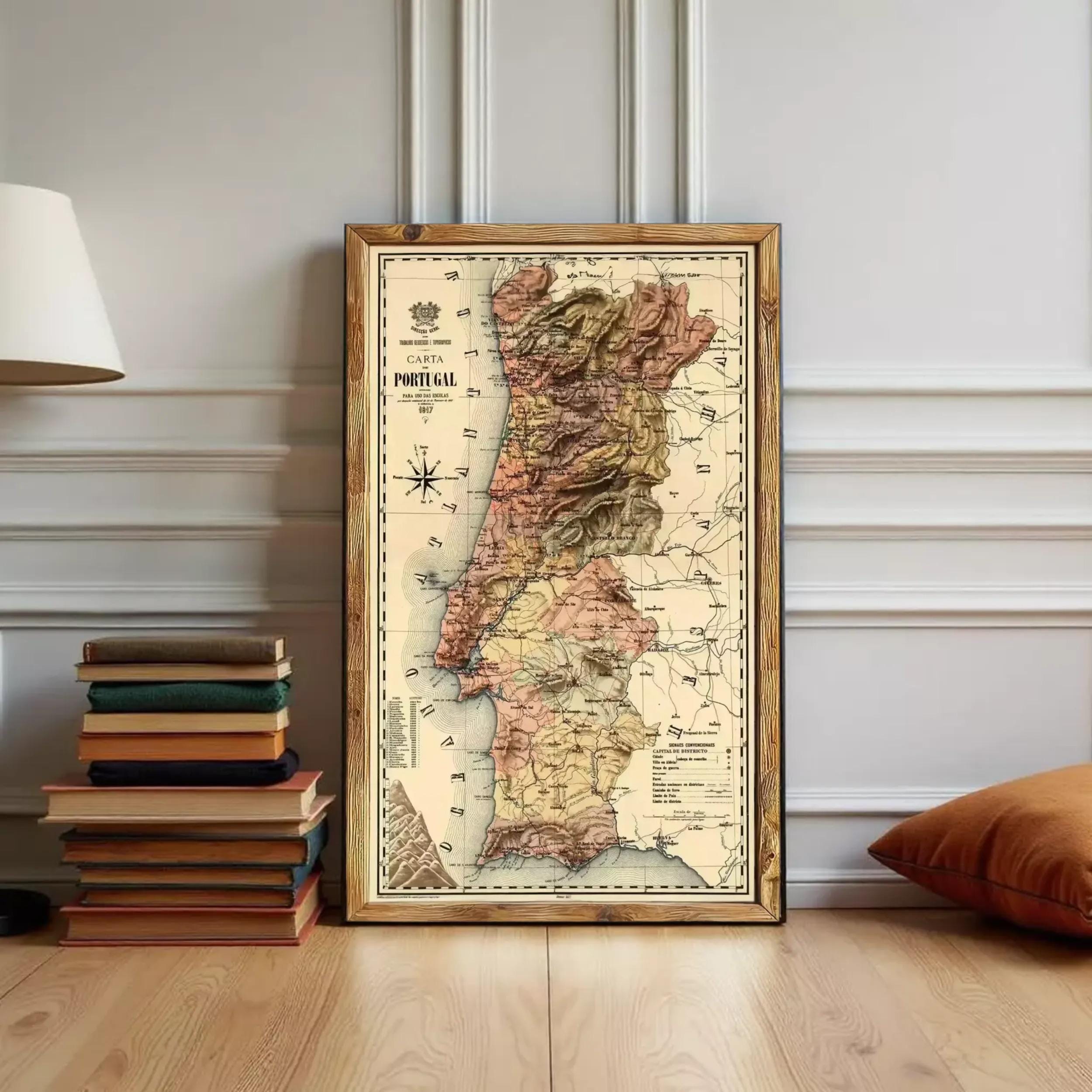 A framed map of Portugal is displayed on a wall, surrounded by a stack of books and a lamp.