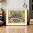 The image is a framed map of a city, likely a historical or geographical map, displayed on a wall.