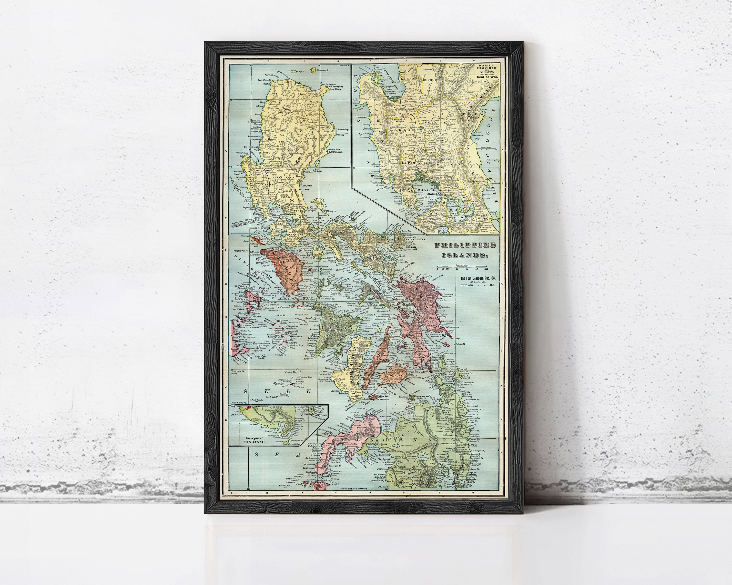 The image is a framed vintage map of the Philippines, showing the country's geographical layout and surrounding areas.