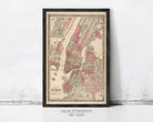 The image is a framed vintage map of New York City, depicting the city's streets, neighborhoods, and surrounding areas.
