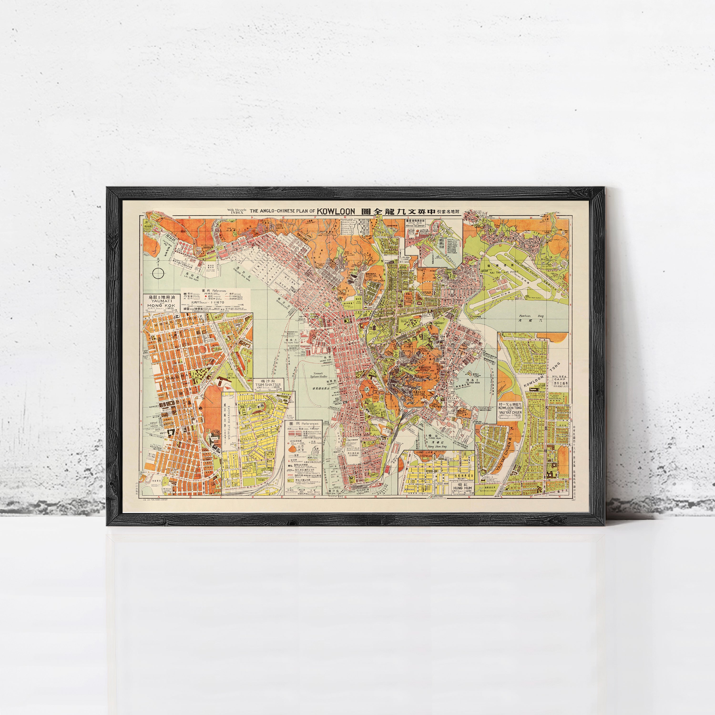 The image is a framed vintage map of a city, depicting various streets, landmarks, and geographical features.