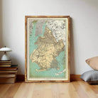 The image is a framed vintage map of New York City, depicting the city's streets and surrounding areas.