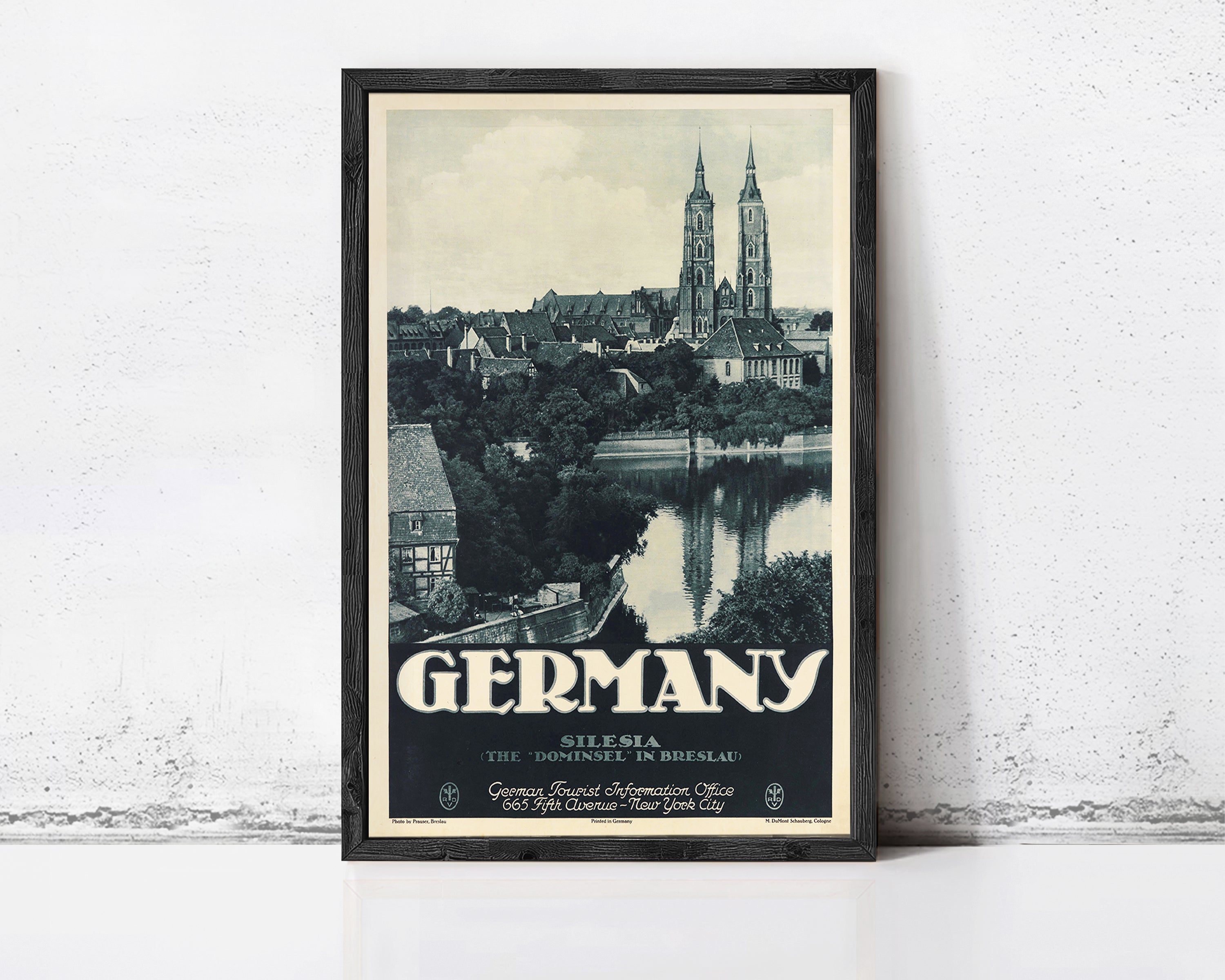A framed vintage travel poster depicting the city of Silesia, Germany, with the city's iconic landmarks such as St. Peter's Basilica and the Neckar River in the background.