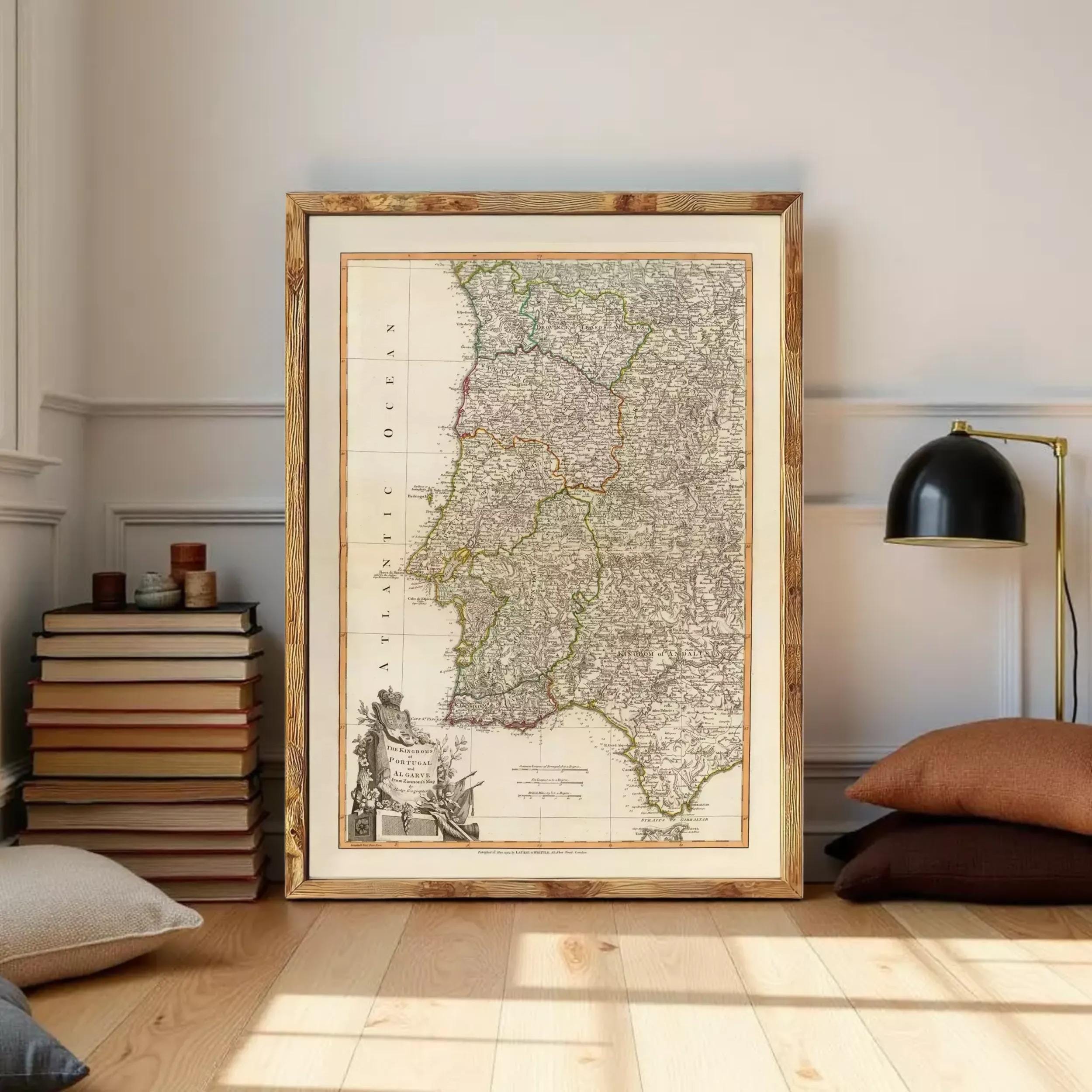 a large framed map of Portugal, with a stack of books and a lamp in the background.