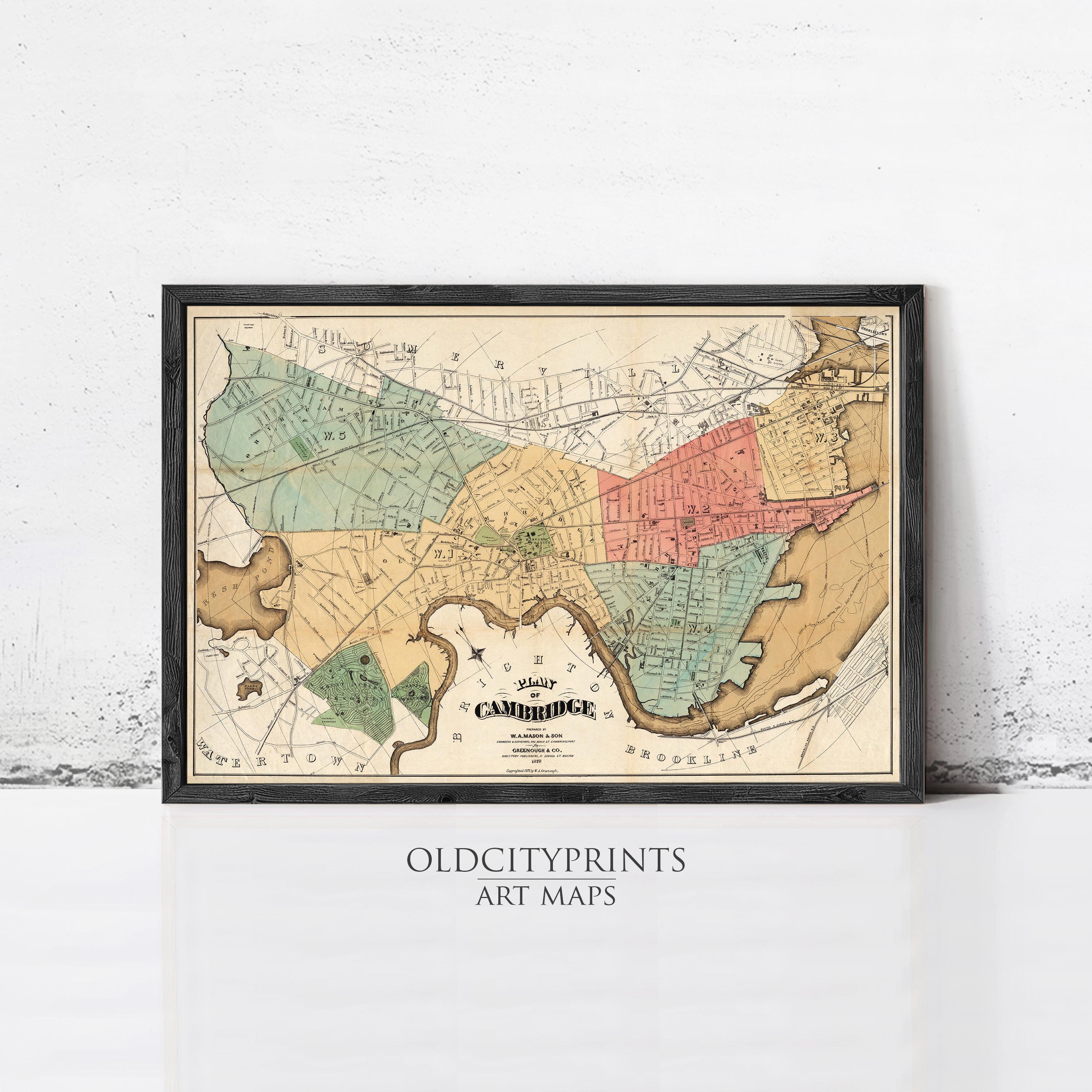 The image is a framed vintage map of Cambridge, Massachusetts, with various colored sections representing different neighborhoods and streets.