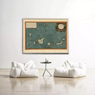 a large framed map of the Caribbean Sea hanging on a white wall, with two white bean bag chairs positioned in front of it.