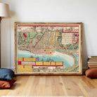 The image is a framed vintage map of a city, depicting various landmarks and geographical features.